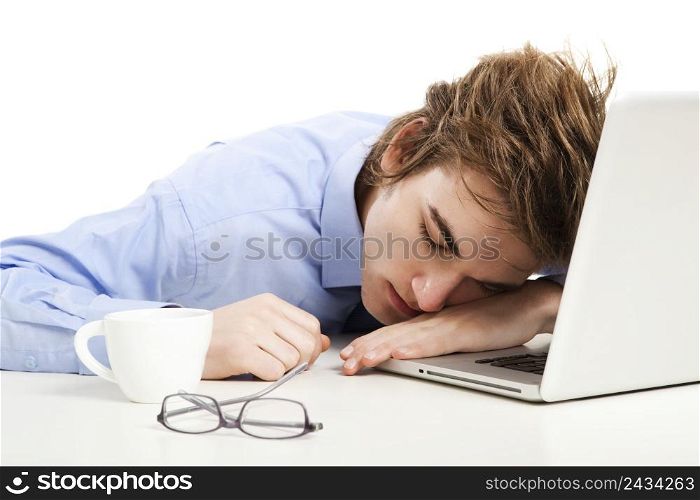 Exhausted businessman in the office sleeping over the laptop