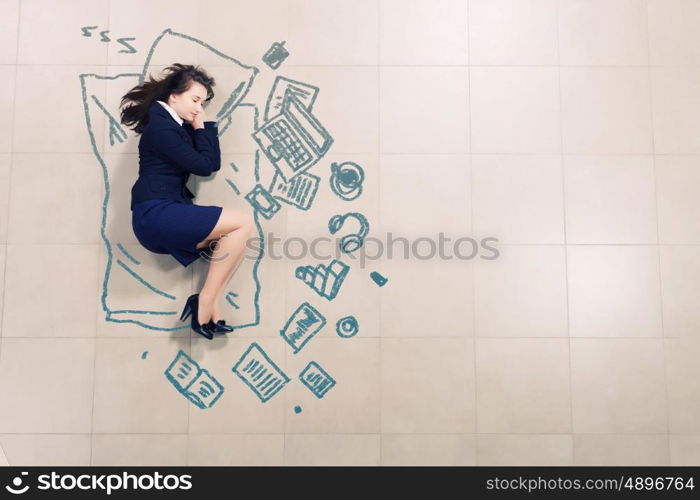 Exhausted businesswoman. Tired businesswoman sleeping on floor and dreaming