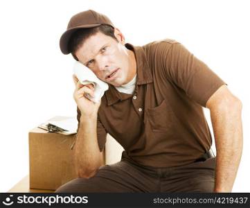 Exhausted delivery guy takes a break. Isolated on white.