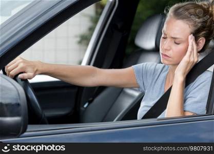 exhausted overworked female driver feels sleepy and tired