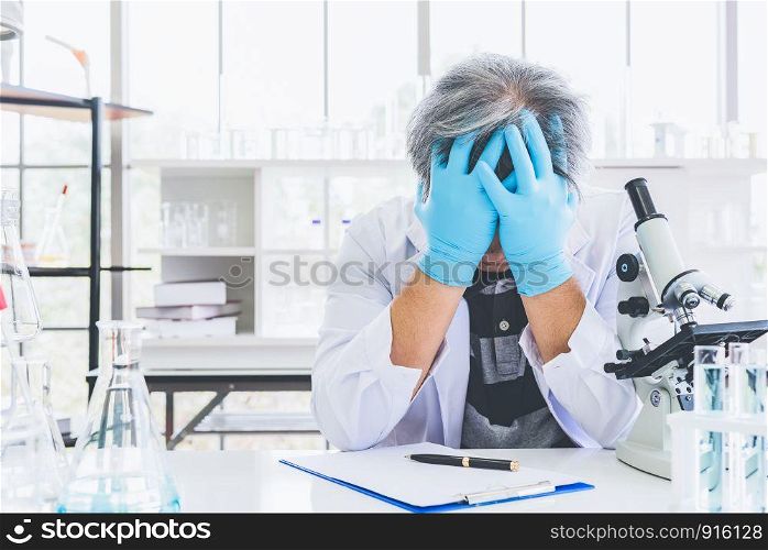 Exhausted scientist sleeping in laboratory. People lifestyles and occupation concept. Science and experiment in lab theme.