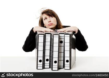 Exhausted woman in the office full of folders and work to do, isolated on white background