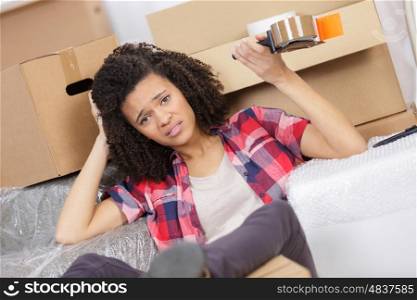 exhausted woman with packages for house moving