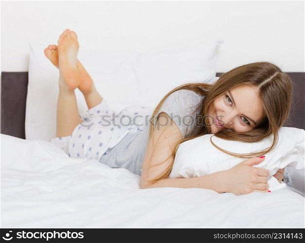 Exhaustion lazi≠ss relax fun joy concept. Cheerful girl rolling in bed. Lazy youthful lady lying onπllow in morning unab≤to≥t up.. Cheerful girl rolling in bed.