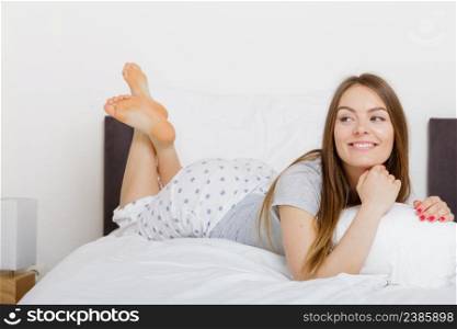 Exhaustion laziness relax fun joy concept. Cheerful girl rolling in bed. Lazy youthful lady lying on pillow in morning unable to get up.. Cheerful girl rolling in bed.