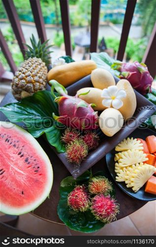 Exotic fruits, juicy, natural filming. Mango, papaya, dragon fruit, rambutan, pineapple