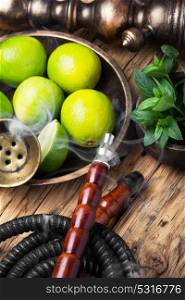 exotic nargile with lime. Arabic hookah with a tobacco flavor of a mixture of lime and peppermint