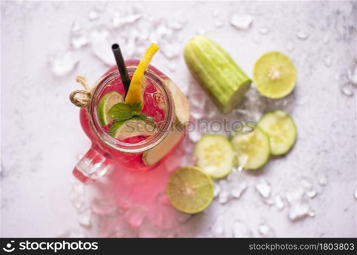 Exotic summer drinks refreshing of cold drinks glasses jar fresh fruit and vegetable on ice homemade cocktail tea with mojito lemon lime and cucumber, Colorful summer drink juicy red pink