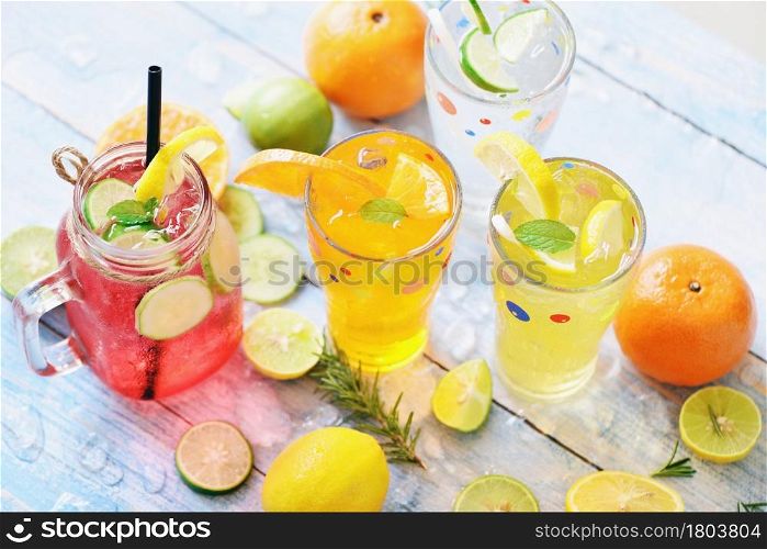 Exotic summer drinks refreshing variety of cold drinks glasses fresh fruit and vegetable on ice homemade cocktail tea with mojito lemon lime orange rosemary and cucumber, Colorful summer drink juicy