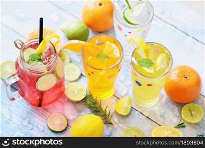 Exotic summer drinks refreshing variety of cold drinks glasses fresh fruit and vegetable on ice homemade cocktail tea with mojito lemon lime orange rosemary and cucumber, Colorful summer drink juicy
