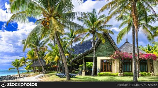 Exotic tropical holidays in Mauritius island. Beach villa under palm trees