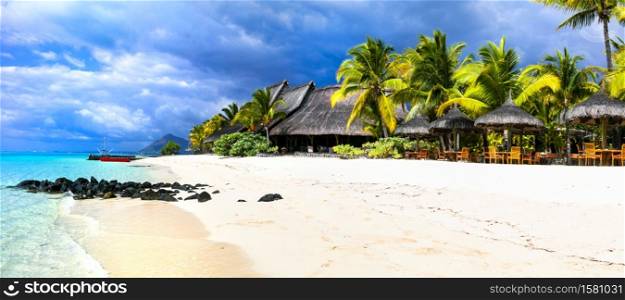 Exotic tropical holidays in Mauritius island. Beach villas under palm trees