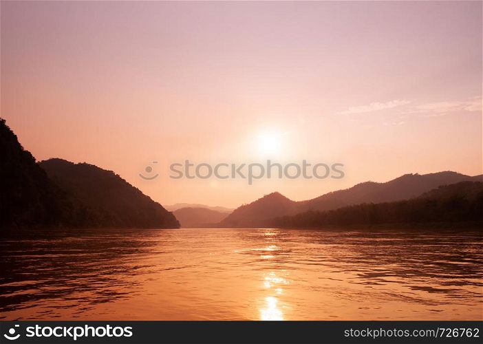 Exotic warm peaceful Mae khong river sunset with mountain view in Luang Prabang - Laos
