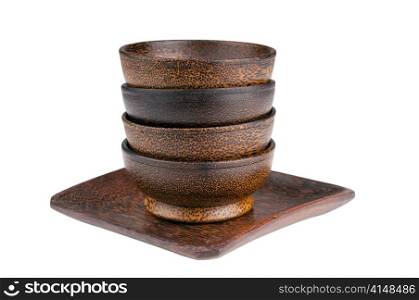 Exotic wooden bowls in a stack isolated over white