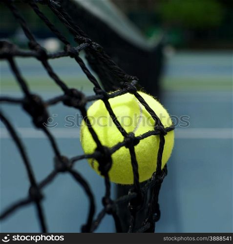 exotic yellow color tennis ball in the net