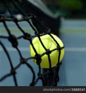 exotic yellow color tennis ball in the net