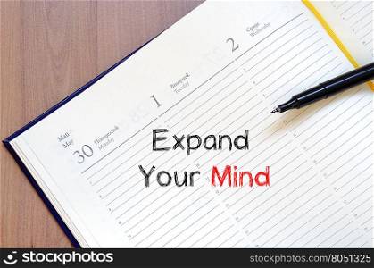 Expand your mind text concept write on notebook