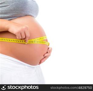 Expectant female measuring tummy by yellow centimeter isolated on white background, baby care, happy motherhood, new life concept