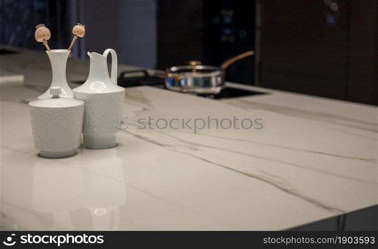 Expensive Luxury Kitchen with Stone Surface Counter and Stove in Background