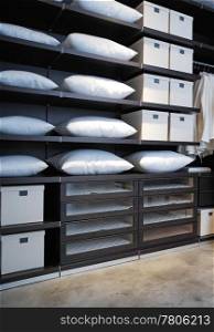 expensive shelving in the boutique with pillows and boxes