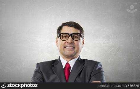 Experienced adult businessman. Cool senior businessman with arms crossed on chest