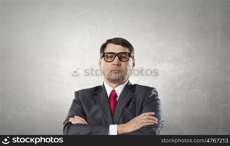 Experienced adult businessman. Cool senior businessman with arms crossed on chest