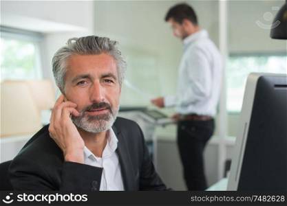 experienced businessman on the phone at workplace