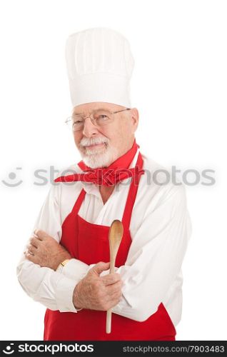 Experienced older chef holding a wooden spoon. Serious expression, isolated on white.