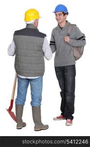 Experienced tradesman meeting his new apprentice for the first time