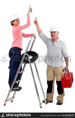 Experienced tradesman pointing to his assistant