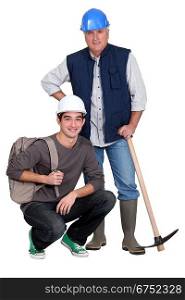 Experienced tradesman posing with his new apprentice