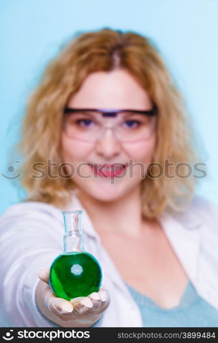 Experiment, research in progress. Chemist woman or student girl, laboratory assistant or scientific researcher with chemical glassware test flask on blue