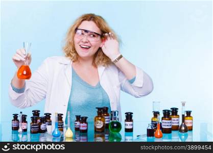 Experiments in laboratory. Chemist woman or student girl, scientific researcher with chemical glassware holding hand to ear listening on blue