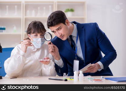 Expert criminologist working in the lab for evidence