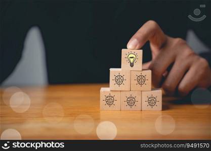 Expertise and support concept. Wooden cubes with light bulb icon on hand icon, suggesting a solution with copy space. Consultation for business development and growth.