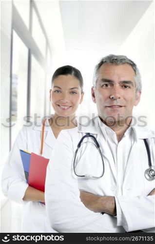 expertise gray hair doctor beautiful nurse in hospital white corridor