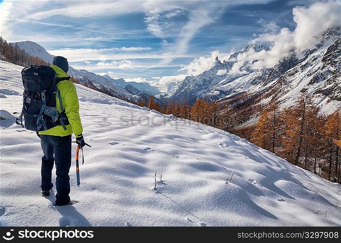 Exploration concept: a lonely hiker in the wilderness. Mont Blanc massif, Val Ferret, Courmayeur, Valle d&acute;aosta, Italy.