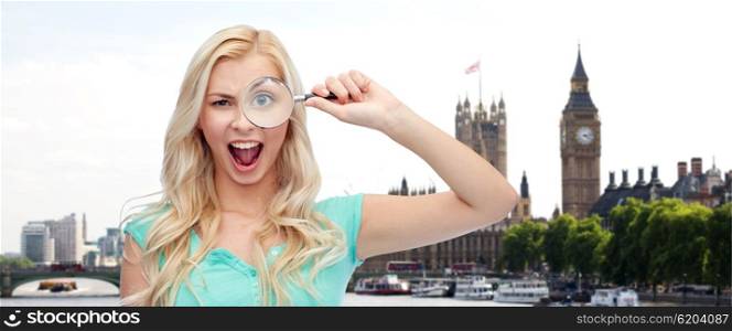 exploration, travel, tourism, and people concept - happy smiling young woman or teenage girl looking through magnifying glass over london city and big ben tower background