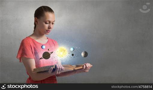 Explore space planets. Close view of woman holding opened book and planets on pages