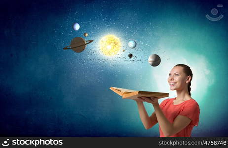 Explore space planets. Young pretty woman holding opened book and planets on pages