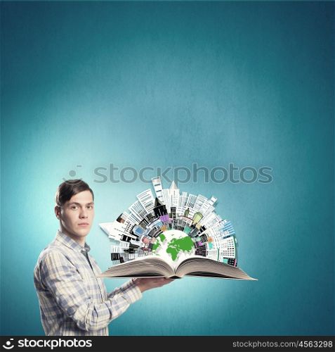 Exploring the world. Young student guy with opened book in hands