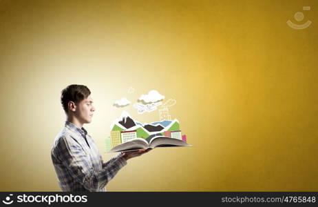 Exploring the world. Young student guy with opened book in hands