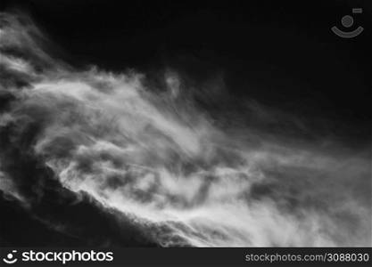 Explosion by an impact of a cloud of particles of powder of color white on a black background.