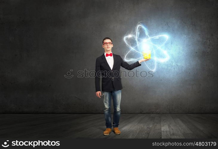 Express your creative individuality. Young man in jacket and red glasses with yellow bucket in hands