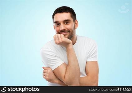 expression and people concept - happy smiling man over blue background. smiling man over blue background