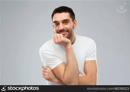 expression and people concept - happy smiling man over gray background. smiling man over gray background