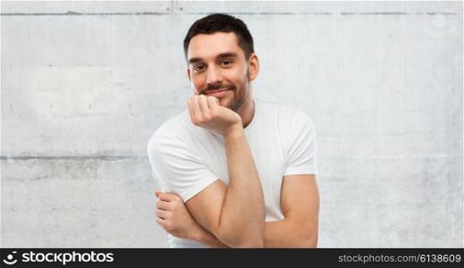 expression and people concept - happy smiling man over gray stone wall background. smiling man over gray background