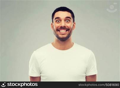 expression and people concept - man with funny face over gray background. man with funny face over gray background
