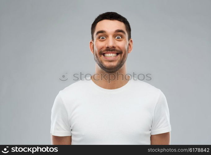 expression and people concept - man with funny face over gray background. man with funny face over gray background