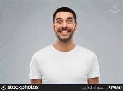 expression and people concept - man with funny face over gray background. man with funny face over gray background